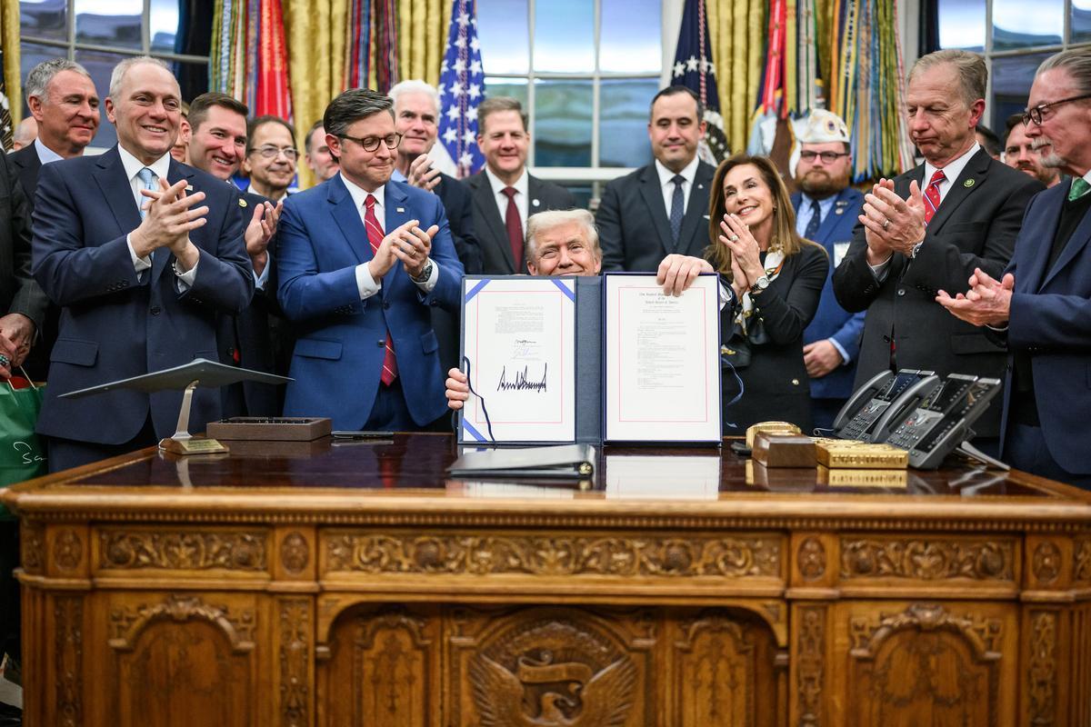 Washington, D.C. - President Donald Trump shows the media the bill signed by Congress to reopen the government, Wednesday, November 12, 2025, in the Oval Office. (Official White House Photo by Daniel Torok)