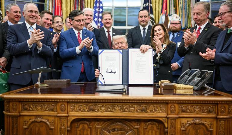 Washington, D.C. - President Donald Trump shows the media the bill signed by Congress to reopen the government, Wednesday, November 12, 2025, in the Oval Office. (Official White House Photo by Daniel Torok)