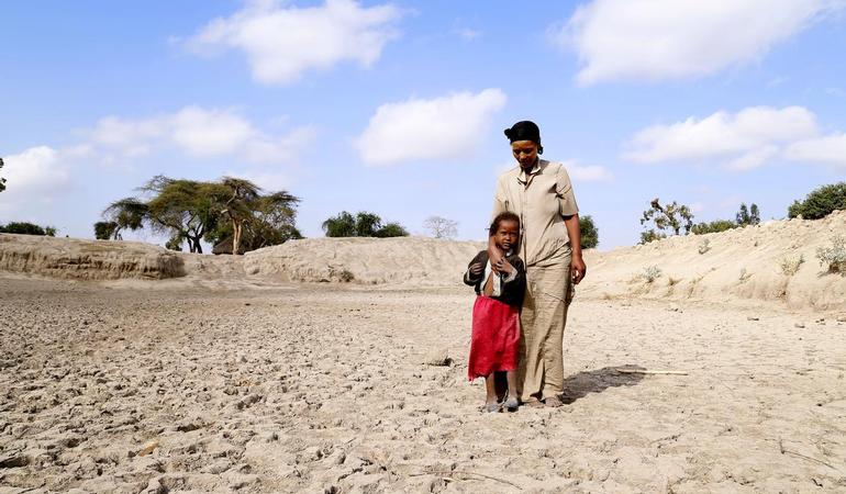 Badoo Fukura, 28, stands at the bottom of a basin that used to be the community watering hole. It served about 30 different families here, near the small town of Aje, south of the capital Addis Ababa (Photo USAid - Flickr)