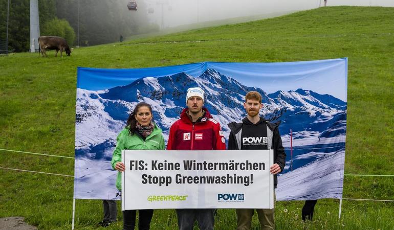 Tirolo, maggio 2023. Da sinistra, Ursula Bittner (Greenpeace), Julian Schütter e Moritz Nachtschatt (Protect our winters Austria) reggono uno striscione che recita: "Fis: niente favole, basta greenwashing!". Foto di Milko Stoev/Protect our winters