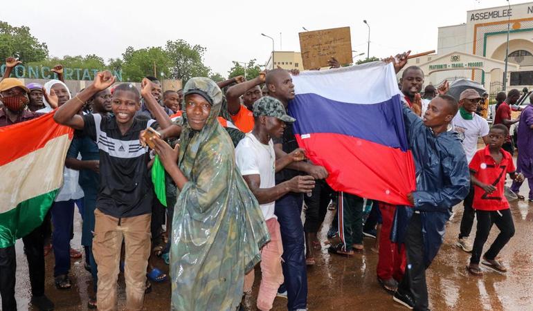 27 luglio 2023, Niamey, Niger. I sostenitori dei soldati golpisti mostrano le bandiere del Niger e della Russia mentre festeggiano fuori dall'edificio dell'Assemblea nazionale EPA/STR/Ansa