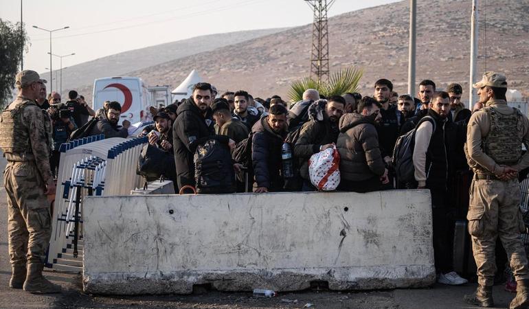 Confine turco-siriano, 10 dicembre 2024. Rifugiati in fila al valico di frontiera per rientrare in Siria dopo la caduta di Bashar al Assad. Foto di Kazim Kizil/Ansa